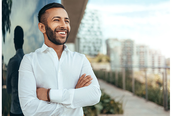 man smiling with arms crossed