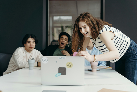 a group of people looking at a computer